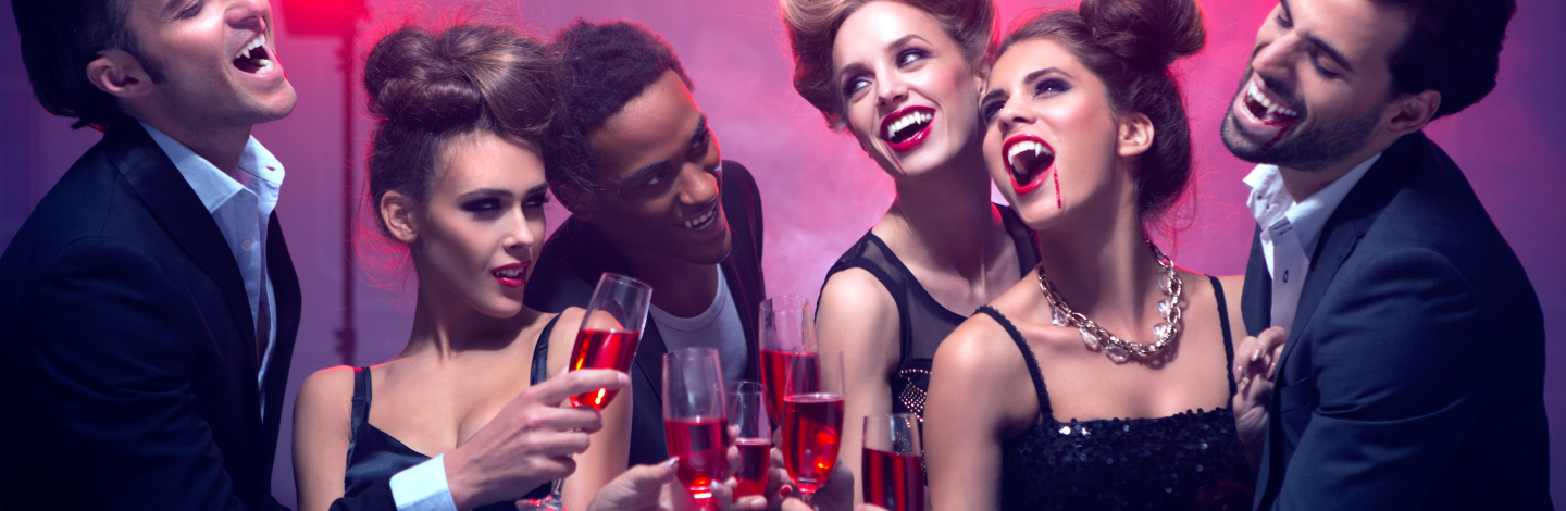 group with champagne glasses and halloween costumes 