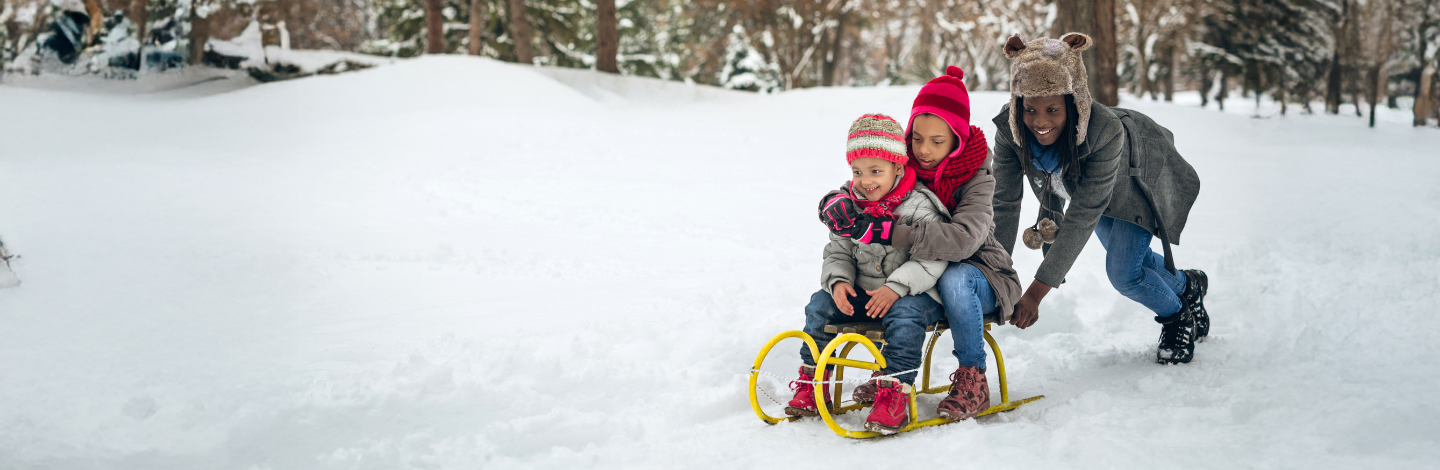 Three boys sled together