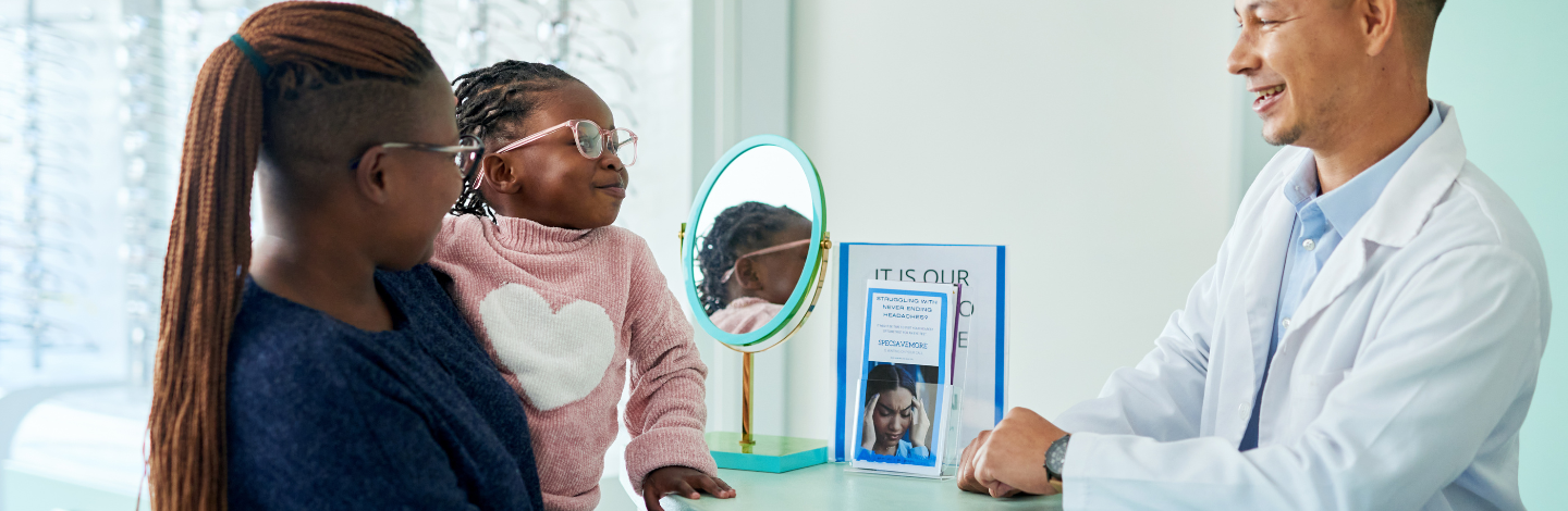 mom and small girl talk to optometrist 