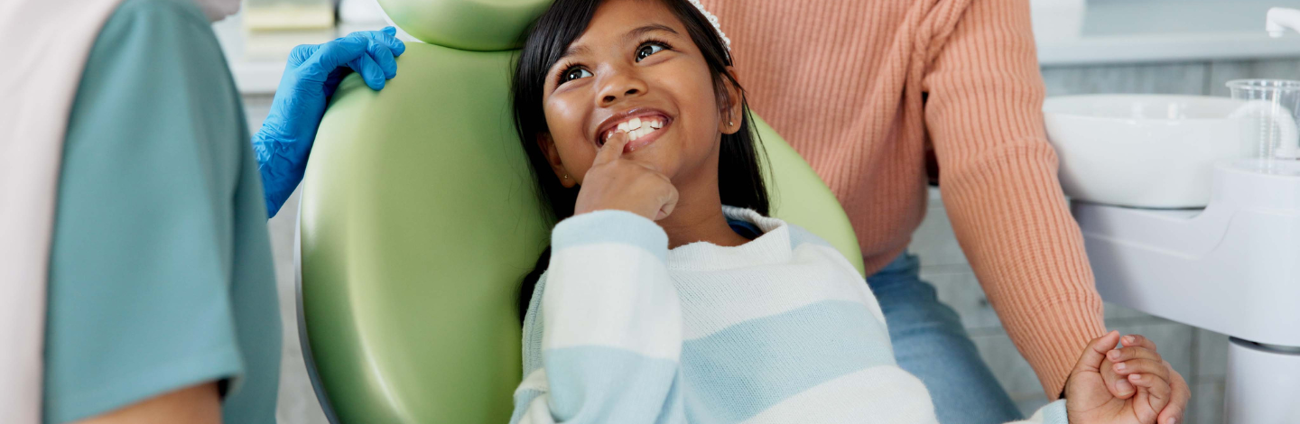 Young girl smiles at dentist office
