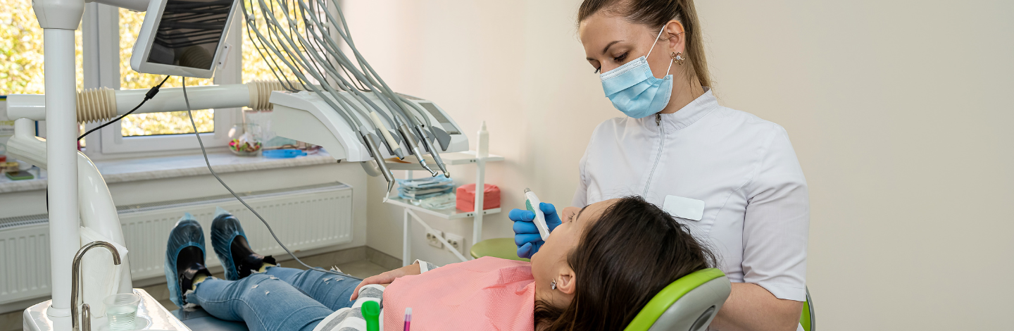 Dental hygienist cleans patients teeth