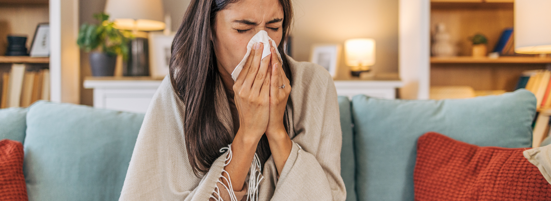 woman sneezing on couch