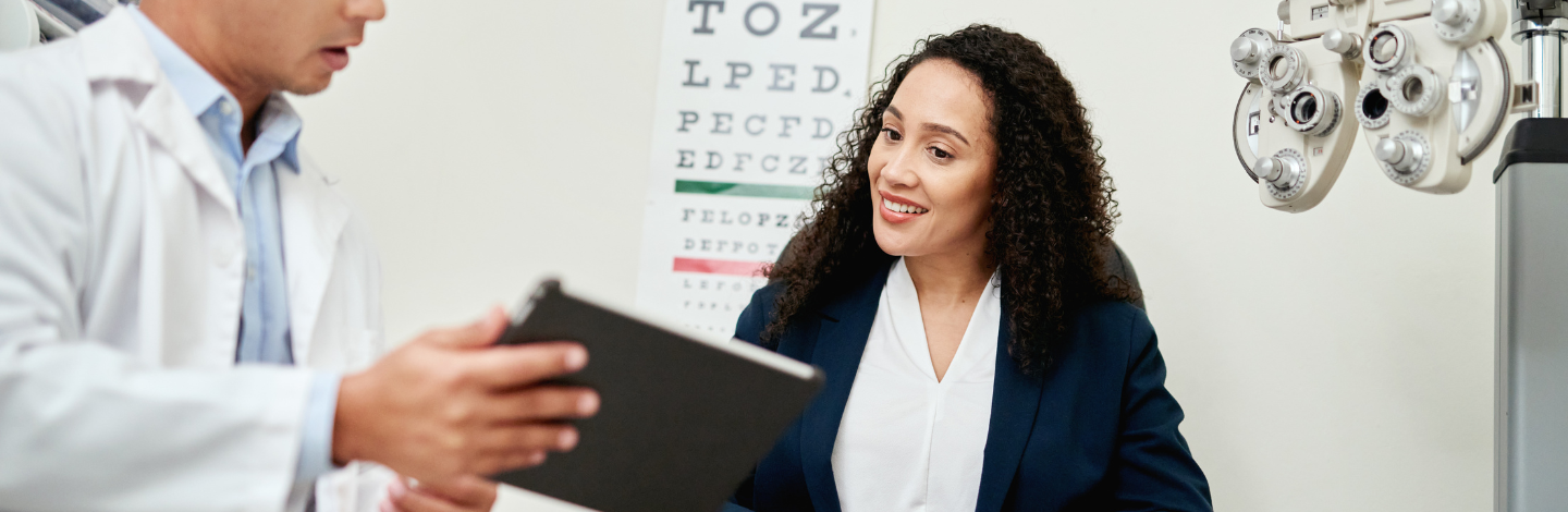 Woman looks at chart in eye exam
