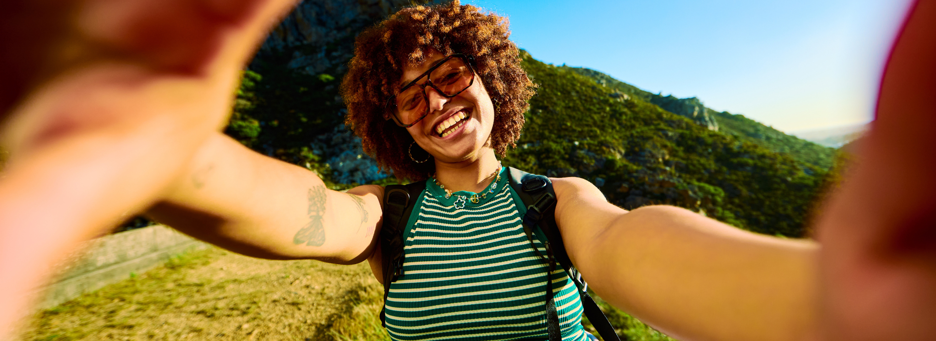 Young woman taking selfie while enjoying a mindful hike in nature