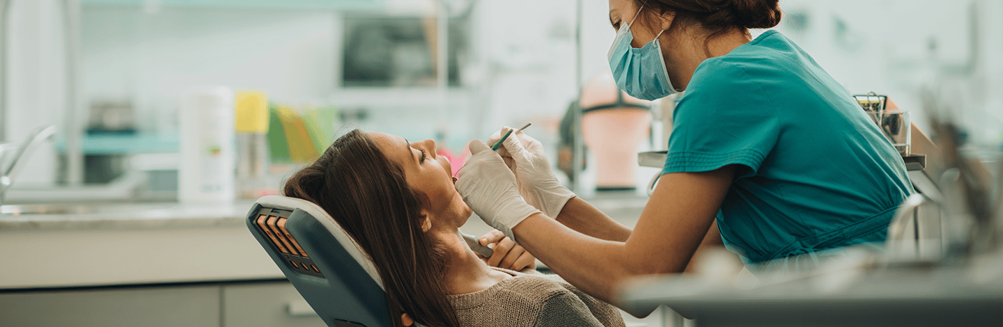 Dentist checks patients teeth