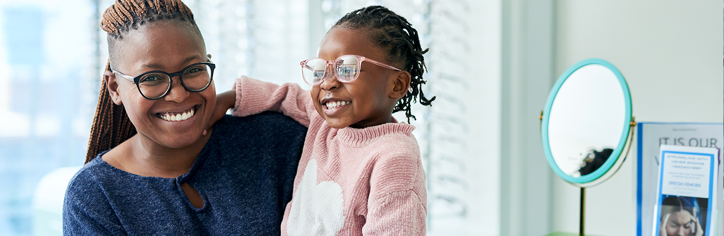 mom and daughter smile with glasses on