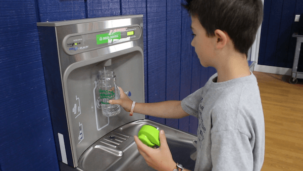 kid at water fountain