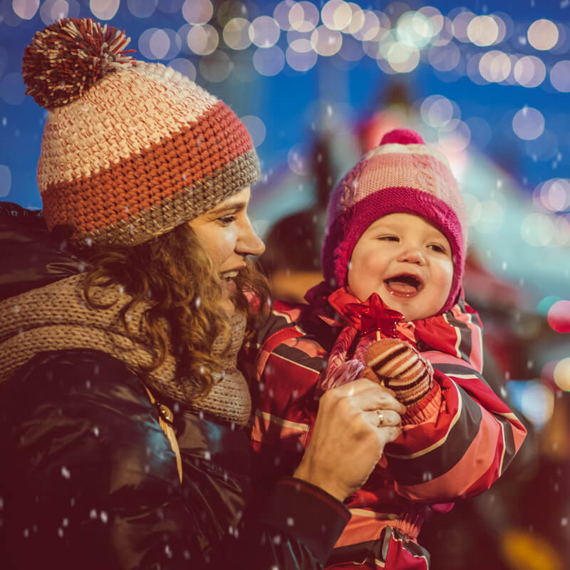 mom-holding-baby-outside-in-snow-800x800