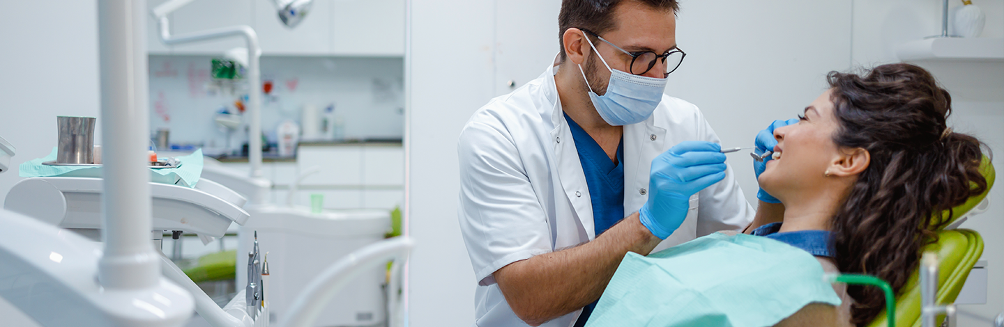 Dentist checks teeth of patient