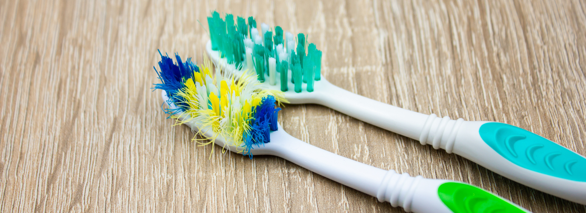 Old and new toothbrush. Used and new toothbrush comparison. Toothbrush with frayed bristles.
